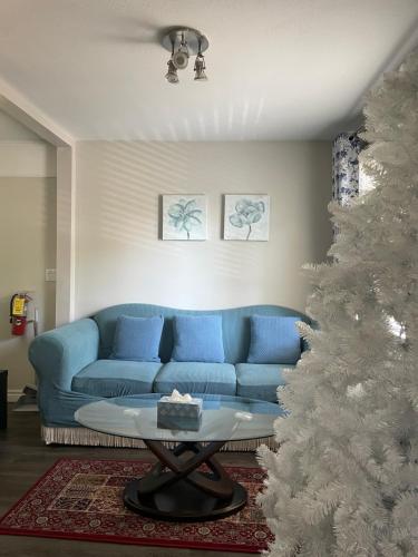 a living room with a blue couch and a christmas tree at Cozy Home in Niagara-on-the-Lake in Niagara on the Lake