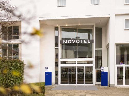 a nootir sign on the front of a building at Novotel Brugge Centrum in Bruges