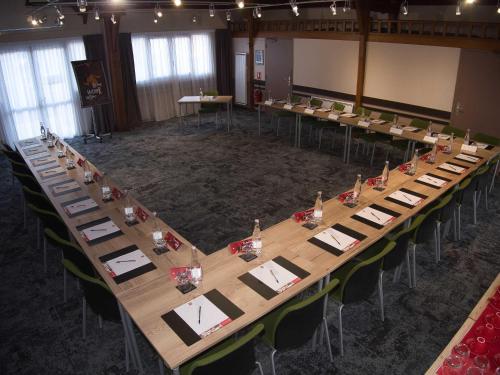 a large conference room with a long table and chairs at Ibis Château-Thierry in Essômes-sur-Marne