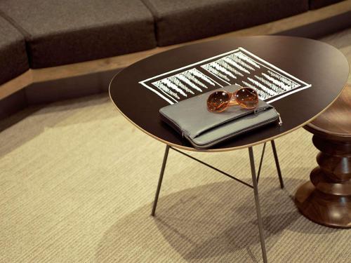 a small table with a pair of glasses on it at ibis Hotel Brussels off Grand'Place in Brussels