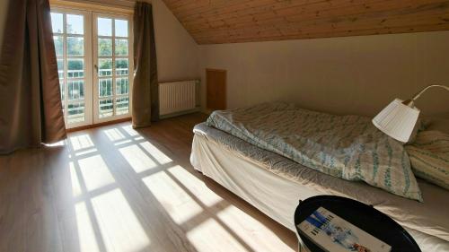 a bedroom with a bed and a large window at Renovated Farmhouse With Starry Sky Views in Barrit