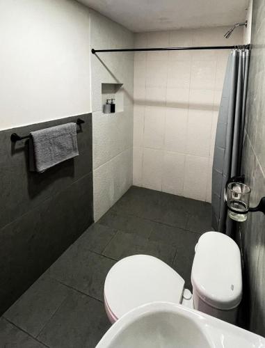a bathroom with a toilet and a sink at Casa rustica con increíbles vistas 