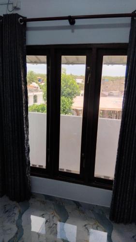 a window with a view of a balcony at VILLA AAA WELIGAMA in Weligama