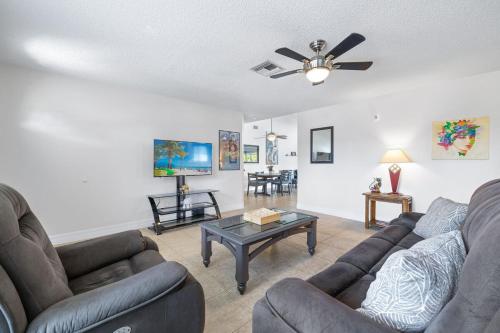 a living room with two couches and a table at Whole cozy house for group of 4 in Cape Coral