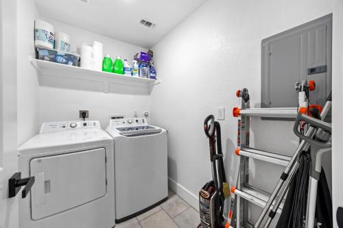 a small laundry room with a washer and dryer at 4BR Modern Getaway by Lackland & SeaWorld in San Antonio