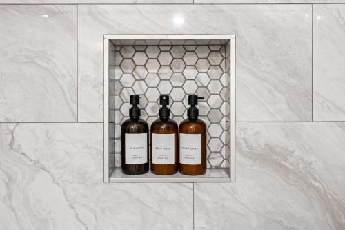 three bottles of wine sitting on a shelf in a wall at 4BR Modern Getaway by Lackland & SeaWorld in San Antonio