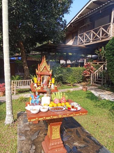 a table with fruit on it in a yard at Jungle View Resort in Ko Chang