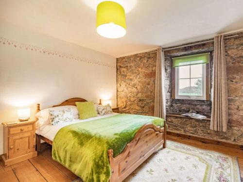 a bedroom with a wooden bed and a window at 2 Bed in Wasdale SZ436 in Santon Bridge