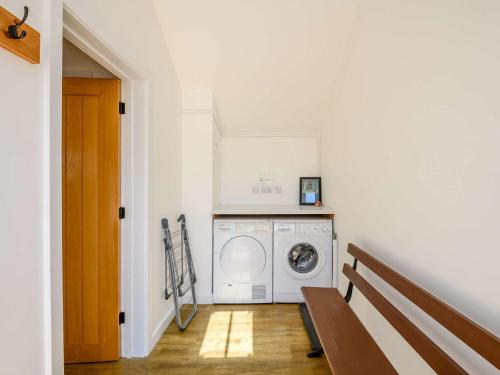 a white laundry room with a washer and dryer at 2 Bed in Fordingbridge 56823 in Woodgreen