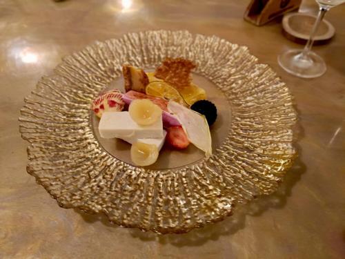 a plate of food on top of a glass plate at Skylodge B&B - Bali Jungle Retreat with Fine Dining & Eco Pool in Bukti