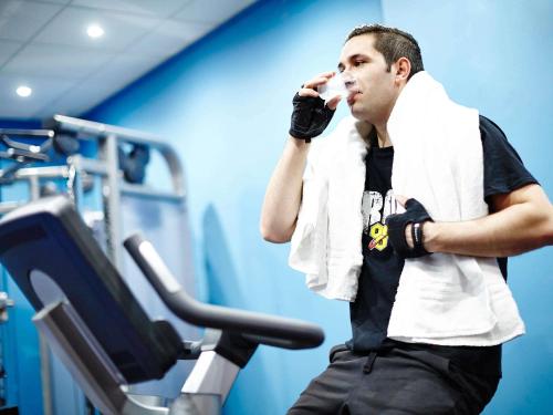 a man in a gym talking on a cell phone at Novotel Birmingham Centre in Birmingham