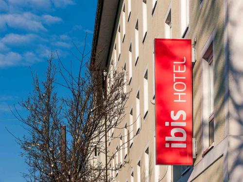 a red sign on the side of a building at ibis Augsburg Koenigsplatz in Augsburg