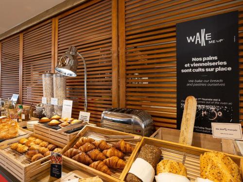 a bakery with various types of bread and pastries at Ibis Angoulême Nord in Champniers