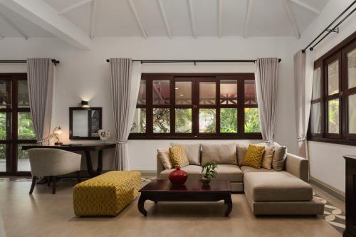 a living room with a couch and a table at Samanea Beach Resort & Spa in Kep