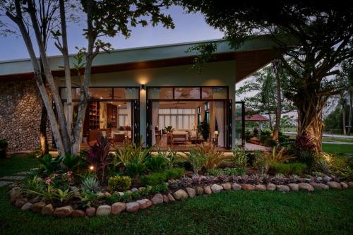 a house with a garden in front of it at Samanea Beach Resort & Spa in Kep
