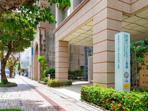a building with a sign on the side of it at Nishitetsu Resort Inn Naha in Naha