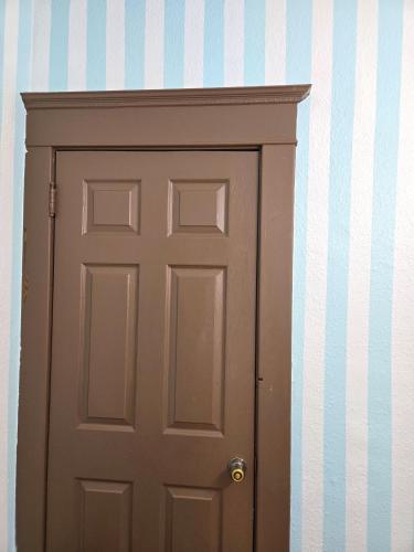 a door in a room with a striped wall at Ana Maria del Azul in Minneapolis
