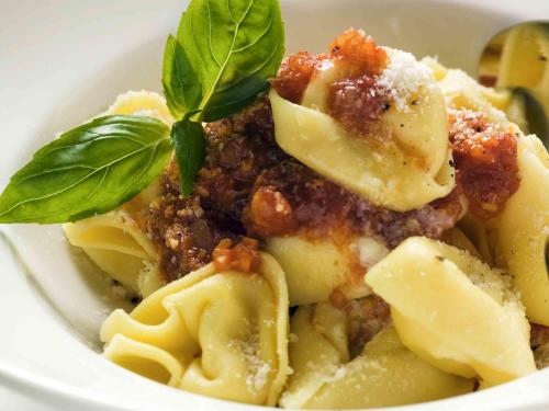 a bowl of pasta with a basil leaf on top at ibis Gap Centre in Gap