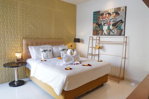 una camera da letto con un letto decorato con fiori di Jineng Febe G Villa a Seminyak