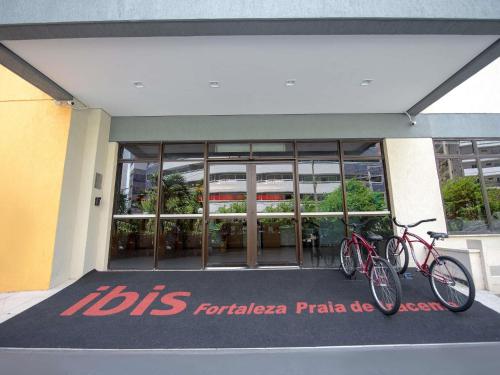 two bikes parked in front of a building at ibis Fortaleza Praia de Iracema in Fortaleza