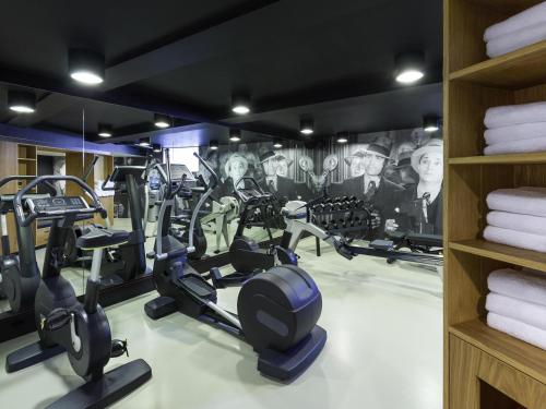 a gym with treadmills and elliptical machines at INK Hotel Amsterdam - MGallery Collection in Amsterdam