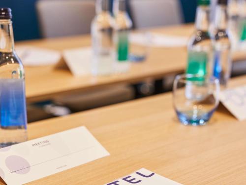 a table with bottles of water on top of it at Novotel Birmingham Airport Terminal Building - NEC in Bickenhill