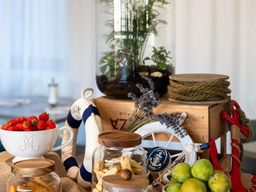 a table with a bowl of fruit and a vase at Mercure Marseille Centre Vieux Port in Marseille