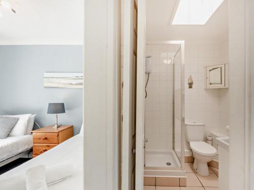 a bathroom with a bed and a toilet and a sink at 2 Bed in Brixham BX079 in Brixham