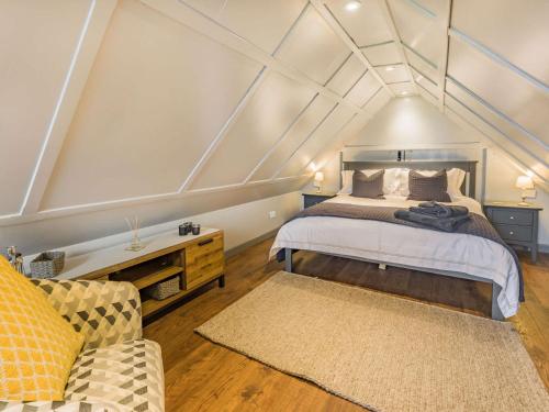 a bedroom with a bed and a couch in a room at 1 Bed in Moccas 87736 in Moccas