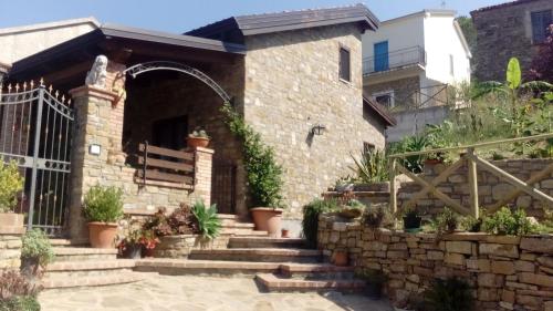 a stone house with stairs and a gate at Il Brillocco in Castellabate