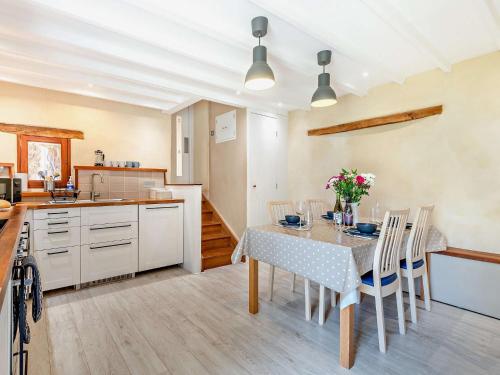 a kitchen and dining room with a table and chairs at 2 Bed in Hope Mansell 73253 in Kerne Bridge