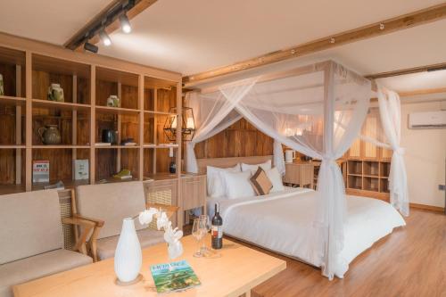 a bedroom with a white bed with a canopy at Gia Trang Heian Hoa Binh in Hòa Bình