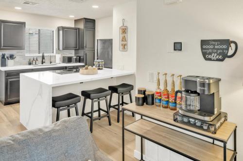 a kitchen with a counter and bar with stools at Sedona Escape- Pool, Spa, Hike, Dine, Relax in Sedona