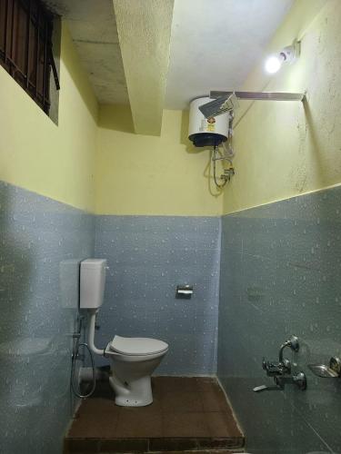 a bathroom with a toilet and a sink at Rose Mary Guest House in Cherrapunji