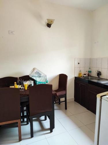 a kitchen with a table and chairs and a sink at Villa Candolim Goa in Candolim