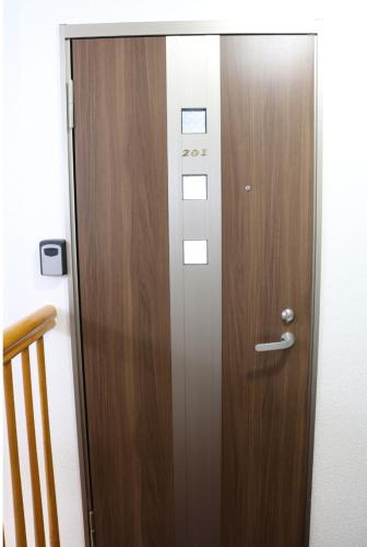 a wooden door in a room with a staircase at 冠京ホテル in Tokyo