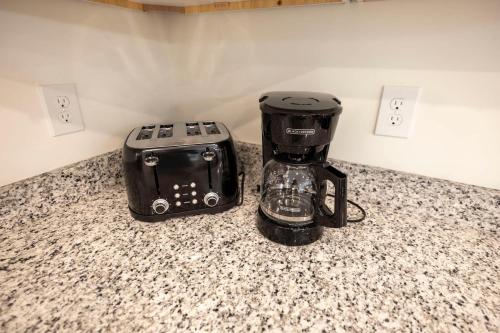 a coffee maker and a toaster sitting on a counter at 4 Min to Downtown - 10 Min to Elon - Washer and Dryer in Burlington