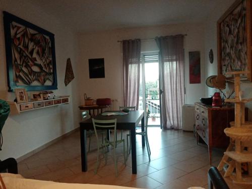 a dining room with a table and chairs in a room at La Finestra sull'Etna in San Gregorio di Catania