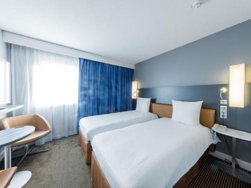 Кровать или кровати в номере Mercure Paris Massy Gare TGV