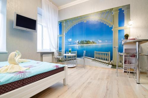 a bedroom with a bed with a view of the ocean at Alfa Apartments Levytskoho 3 in Lviv