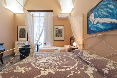 En eller flere senge i et værelse på Palazzo Osanna