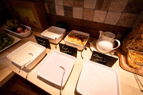 a table with trays of food on top of it at Amselgrundschlösschen in Kurort Rathen