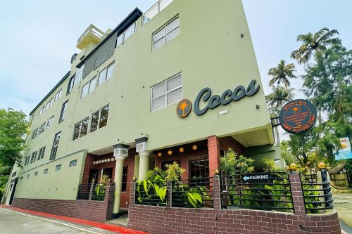 a building with a cocacola sign on the side of it at Cocos Polhena in Matara