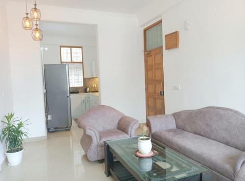 a living room with two couches and a table at Tapovan home by Jabula Getaways in Rishīkesh