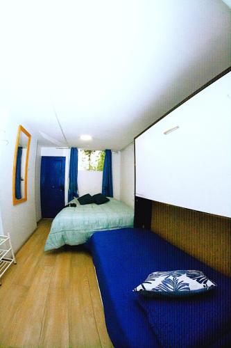 a bedroom with two beds and a blue mattress at Alojamiento Ñuñoa Estadio Nacional in Santiago