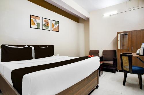 a hotel room with a bed and a desk at Super Collection O NIT More Adityapur Formerly Hotel Subheksha in Jamshedpur