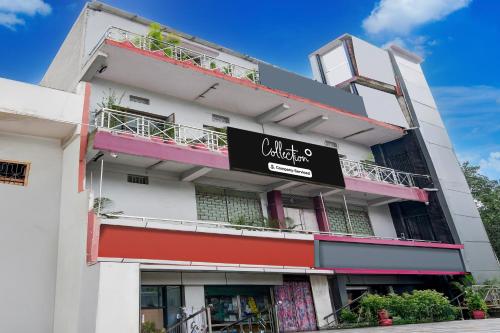 a white building with a black sign on it at Super Collection O NIT More Adityapur Formerly Hotel Subheksha in Jamshedpur