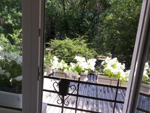 a balcony with a table with white flowers on it at Apartment VIP in Tiraspol