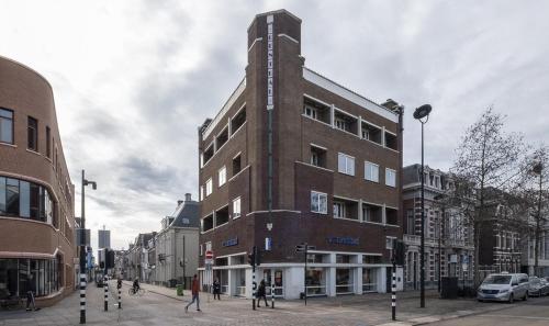 a tall brick building on a city street at Central Tilburg Apartments in Tilburg