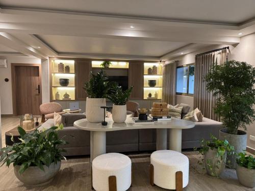 a living room with a couch and a table and stools at Caonabo35 Santo Domingo 207 in Santo Domingo